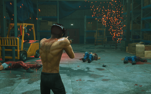 A shirtless male character with a gun stands in a warehouse, facing away from the viewer. Around him, three defeated enemies lie on the blood-splattered floor, with sparks flying in the air. A yellow forklift and shelving units are visible in the background.