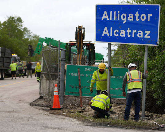 Workers install a sign "Alligator Alcatraz" at the entrance to a new immigrant detention facility at Dade-Collier Training and Transition facility, on Thursday in Ochopee, Florida.
Photograph: Rebecca Blackwell/AP
#resist #authoritarianism #fascism #news #DetentionCamp