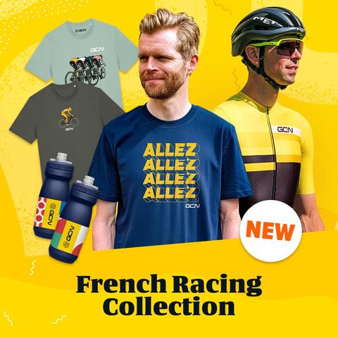 The image features a promotional advertisement for a "French Racing Collection" by GCN. The background is a vibrant yellow with abstract patterns. In the foreground, there are two individuals: one wearing a navy blue t-shirt with the text "ALLEZ ALLEZ ALLEZ" in bold yellow letters, and another in a yellow and black cycling jersey with a black helmet. The t-shirts in the background are light green and dark gray, each with a cycling graphic and the GCN logo. Two water bottles with the GCN logo ar…