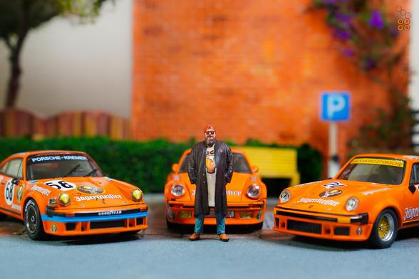 A guy and three Porsche cars on Jägermeister livery in 1:64 scale with 1:64 figure on AREA 164