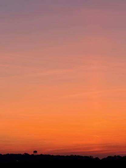 The same sunset moments later, slightly more red and there’s a water tower to the left of the image
