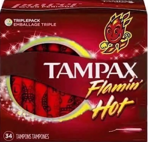 A very low quality, compressed photo of a package of “Tampax Flamin’ Hot” tampons. There is a little fire creature on the box smiling and the tampons inside are red.