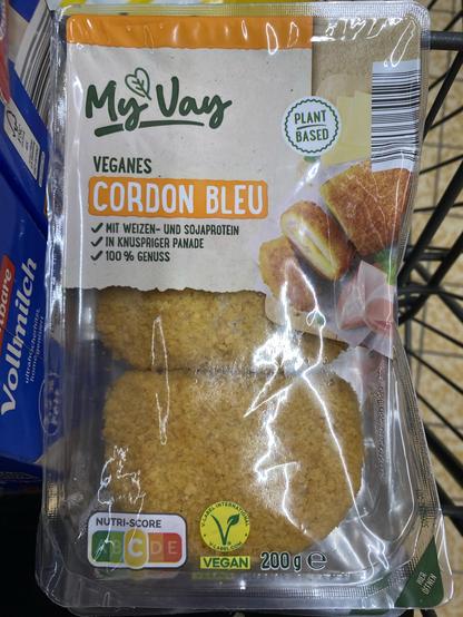 A package of vegan Cordon Bleu from the brand MyVay. The packaging highlights that it is plant-based and made with wheat and soy protein. The contents are shown in a crispy coating. The package also includes a nutri-score and vegan certification