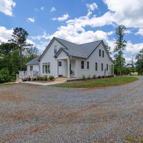 white house with gravel road