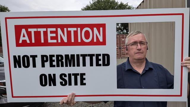 Jim Bicknell Holding the now famous Not Permitted on Site sign