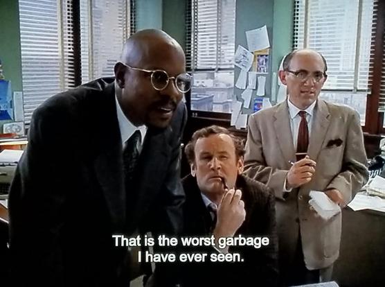 Deep Space Nine scene. The Sisko, Chief Miles Edward O'Brien, and Quark are pictured. But it's like they're just normal earth people in the 1950s, no makeup or loaf. Chief O'Brien, famous for playing the role of "the Force" in the Star Wars series, is shown here smoking a pipe and looking quizzical. All 3 are watching something off screen and looking skeptical. Closed caption reads, "That is the worst garbage I have ever seen."