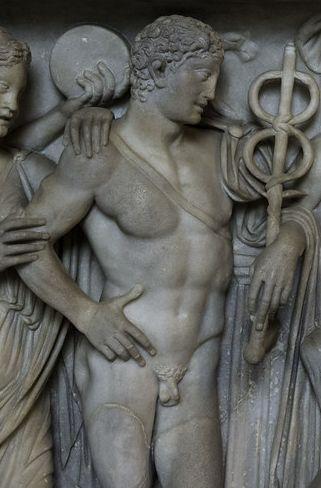 Marble relief of Hermes, standing in the nude, holding his kerykeion staff, his "magic wand". He has short, curly hair and a belt over his breast that looks like a sword belt.