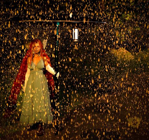3d artwork of Momo, a tall woman with very long ginger hair mainly held in two enormous plaits secured with large gold rings, stands by the side of a road in the dark and rain. 
She is wearing a long, pale blue sundress, long white gloves and large brown leather boots. She is holding a stretched blue and gold cannon vertically, on top of which is a shield of the same material acting as a large umbrella. 
The scene is lit by two street lights just out of shot and a lantern suspended from the underside of the shield. 