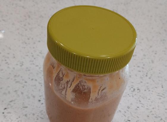 A jar of peanut butter with a mayonnaise lid on it. The lid is green, from an olive-oil style mayonnaise. 

The peanut butter comes from a bulk food shop, so we're not only avoiding a container, but reusing part of another.