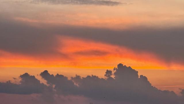 A long shot of fading fiery sunset with lots of interesting clouds