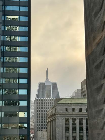 View looking west from the San Francisco financial district with a fully foggy sky in the background.
