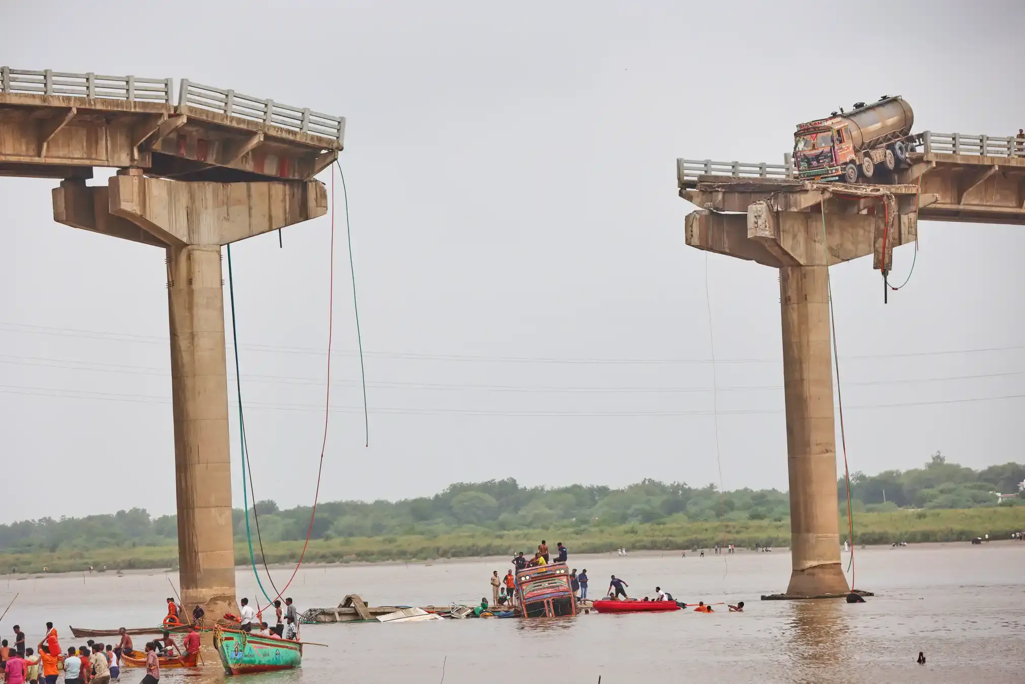 Rescuers and locals look for survivors after several vehicles fell into a river after the collapse of a portion of a bridge.