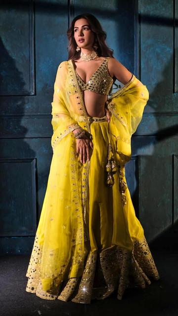 With a soft yellow hue and impeccable styling, Sonal Chauhan’s lehenga ensemble is a perfect festive outfit idea. Her matching dupatta, statement jewellery and glowing look make this one of her most talked about fashion moments.