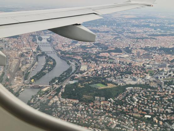 Prague seen from a plane window, the river snaking up, near the Prague Congress Centre. 