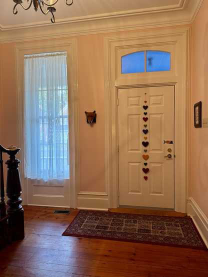 Entry way of 1870’s house with string of hearts on the inside of the door.