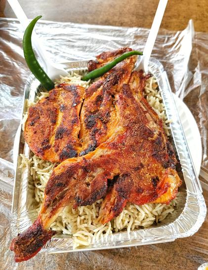 This is not Biryani. It's called Mandi, a traditional dish of Arabs. The cooking method is different. Ingredients and spices are slightly different, but still, I love the Biryani of my country. 🍗😍😋. Tandoori Chicken. With Yellow rice. Green chill is also in it. A huge chicken piece in it. Red colour chicken is in it. Biryani like dish. Close up shot of food. Full meal. Delicious and mouth watering looking.