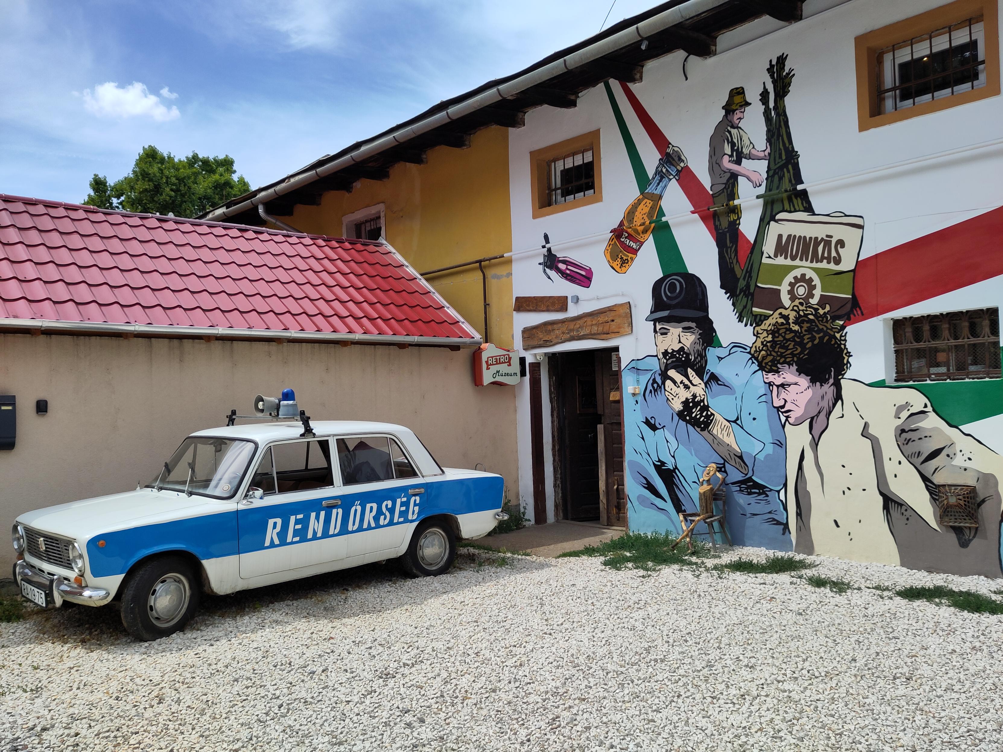 Entrance to the Museum with a Lada 70-s/80s- Hungarian Police car parked next to it.