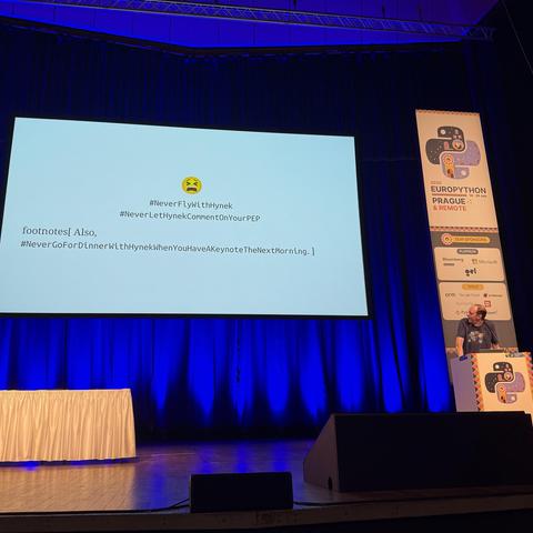 Brett Cannon keynoting about lockfiles. With the classic #neverFlyWithHynek hashtag expanded with #NeverLetHynekCommentOnYourPEP and due to recent events #NeverGoForDinnerWithHynekWhenYouHaveAKeynoteTheNextMorning
