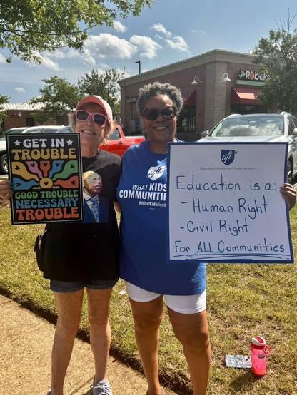 Protesters showing signs at Make Good Trouble rally.