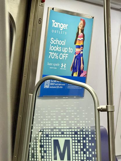 An ad on the Metro train for an outlet mall with up to 70% off for school looks