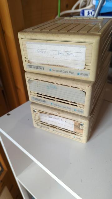 A stack of 3 plastic boxes with the Tandon Computer brand and 30Mb. Inside the boxes are bare 3.5" Winchester drives in a stiffly cushioned frame.

There were no electronics other than an interface and index sensor and the heads were enclosed in a kind of cage off the platters.

The aerodynamics of the start up and slow down let the heads rise and lower.