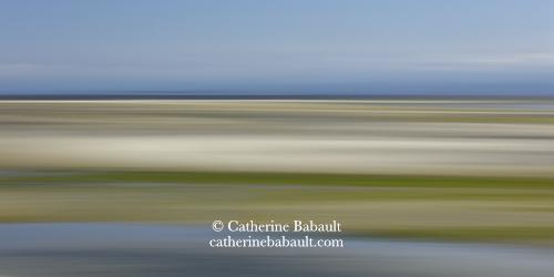 An abstract composition of a sandy beach and blue skies.