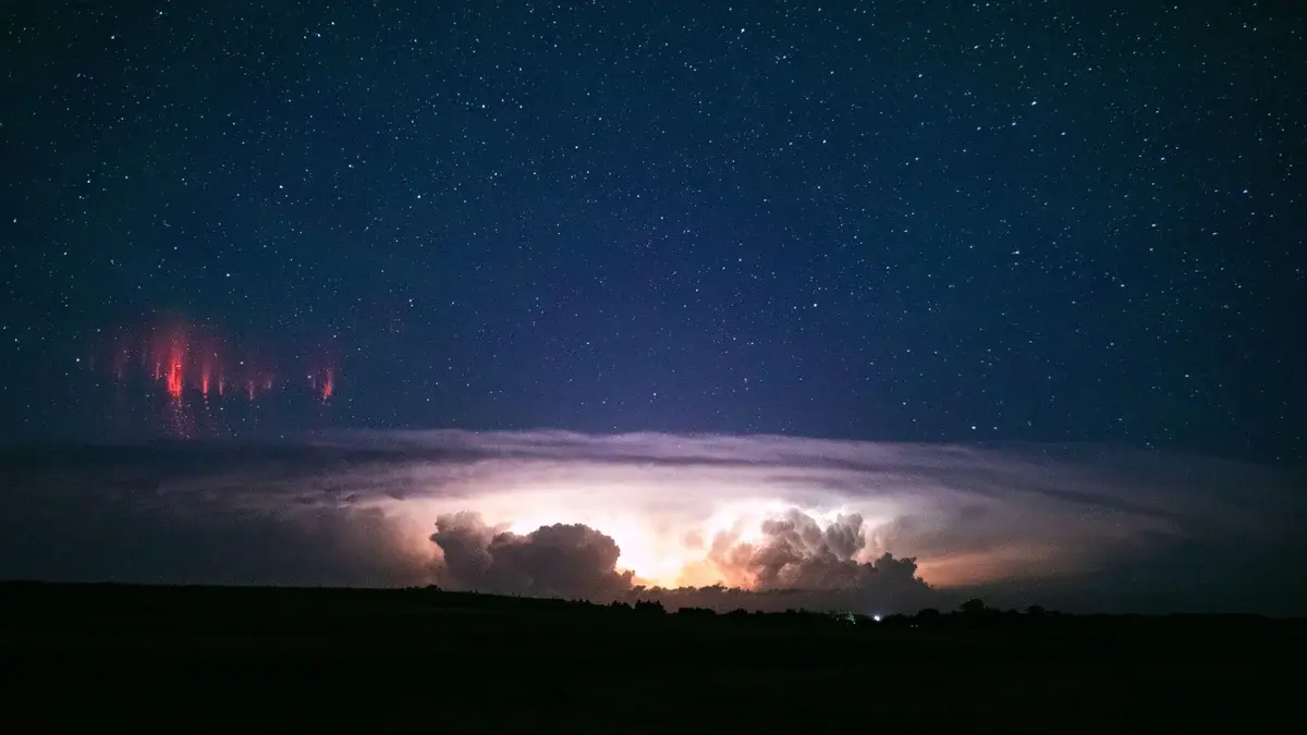 Red sprites over a supercell thunderstorm by John Sirlin. Red sprites over a supercell thunderstorm by John Sirlin.
