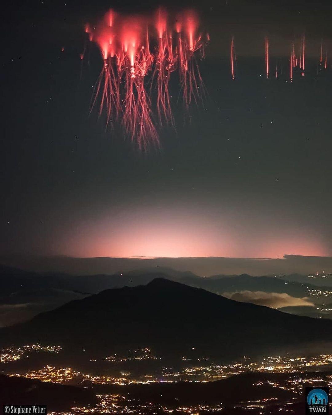 Red sprites over a mountain & a city. Red sprites over a mountain & a city.
