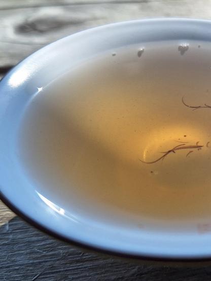 Tea cup with play of shadow and light in the tea
