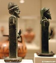 Two herms, simple pillar-shaped statues of Hermes with a head and erect phallus at the appropriate height.