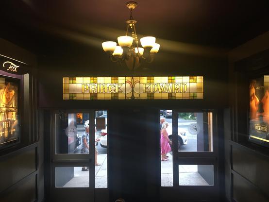 Radiant light filtering through a stained glass window, creating a mosaic of colours.