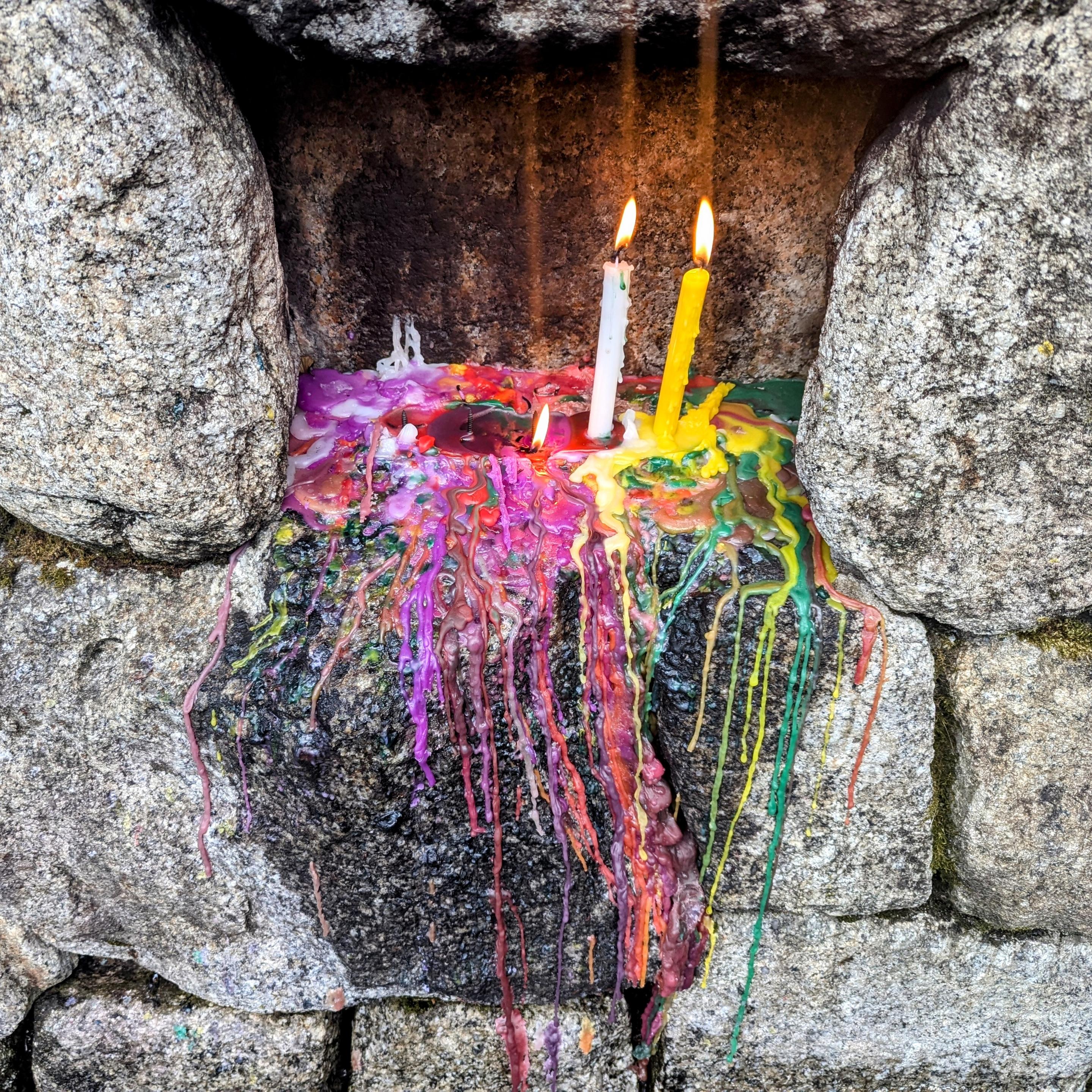 A colourful mess of candle wax, remains of votive candles.
