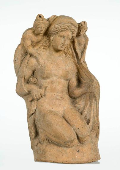 Nude figurine of Aphrodite with two small female figures on her shoulders.