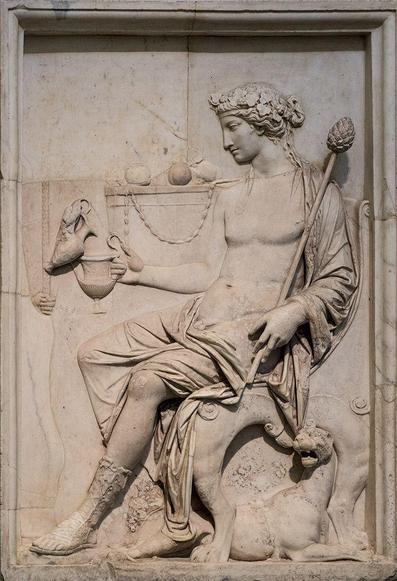 Relief depicting the god Dionysos, seated, receiving wine poured into his kantharos cup. He holds a thyrsos staff in his left arm, extending his kantharos with his right. A panther lies to his feet.