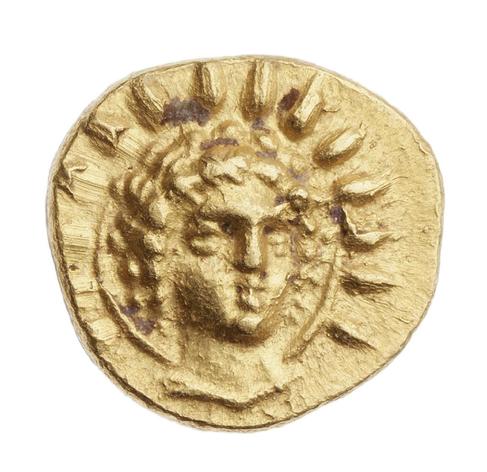 Radiate head of Helios minted on a gold coin. He has curly hair and a 14-spiked aureola around his head. He is looking towards his left.