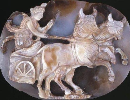 Sardonyx cameo depicting Selene riding her chariot pulled by two bulls. She holds the reins in her right hand and a whip in her left.