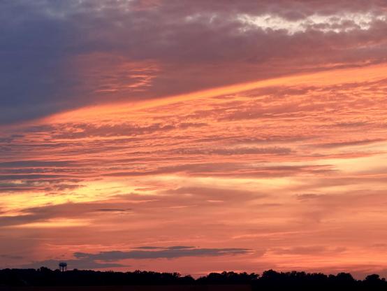 Clouds are glowing red as the sun sets