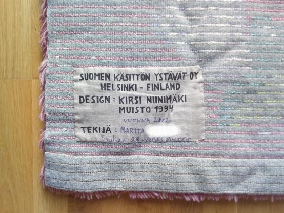 On backside of ryijy, it says:
"Suomen Käsityön Ystävät oy
Helsinki - Finland
Design : Kirsi Niinimäki
Muisto 1994" 
It continues handwritten: "year 2002, maker: Martta ******, Tuulia's 88yo granny" 
I edited her last name away.