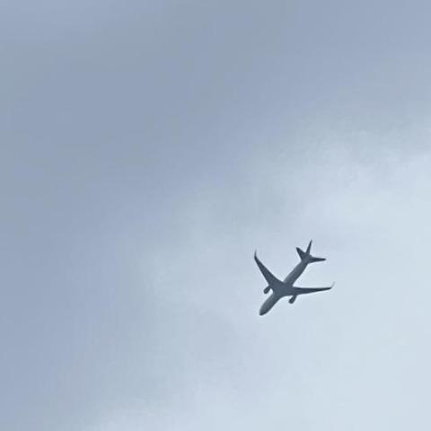 Passenger aircraft descending against a cloud bank