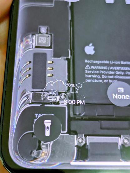 Close-up of iPhone 13 mini displaying the teardown wallpaper with Liquid Glass effect on the edges