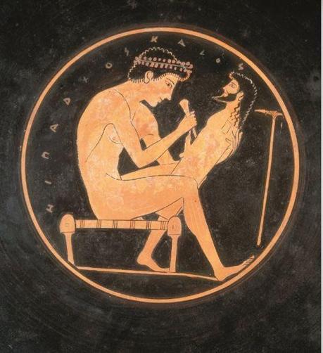 Red-figure kylix depicting a sculptor working on a herm, a simple sculpture of Hermes with a pillar for a body but an elaborate head and an erect phallus at the appropriate height.