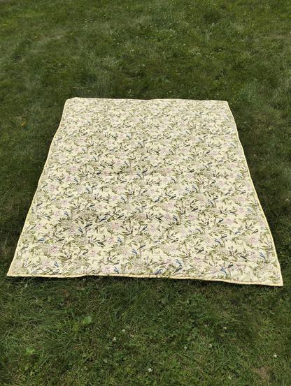 the reverse side of the quilt, it is a floral and bird design