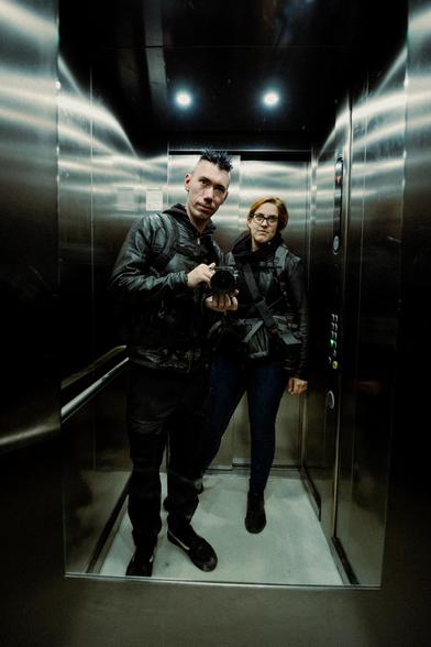 Wide angle self portrait of two photographers in an elevator
