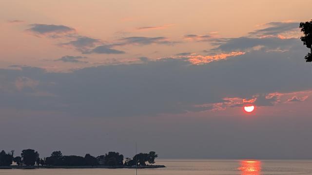 Clouds and sunset over the calm water of Green Bay 