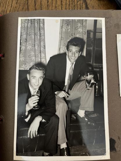 My Dad and his best mate looking like quite the spivs in a black & white photo, holding drinks and cheesing for the camera