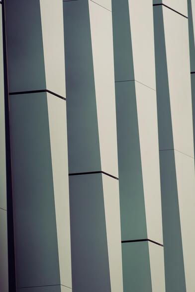 Vertically oriented image of four columns that taper in size from top to bottom with staggered vertical gaps.