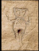 Stone carving of a female figure, using a hole at the appropriate place for the vagina.