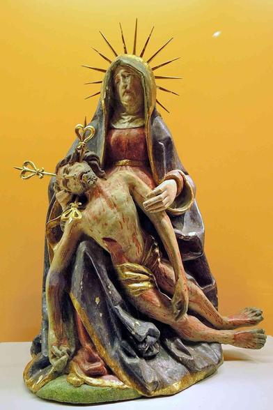A Pietà sculpture depicts the Virgin Mary cradling the body of Jesus Christ.