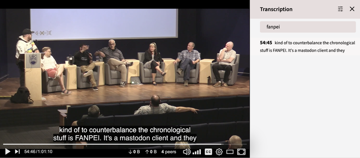 Panel discussion with six people seated on stage and one person standing at a podium, with a video transcript caption visible.

A search on transcriptions is shown for the term "fanpei", mispelled for "Phanpy".