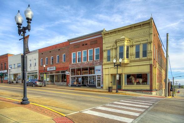 On the bustling corner of Main Street, a stately brick building stands with a striking bay window on the second floor.